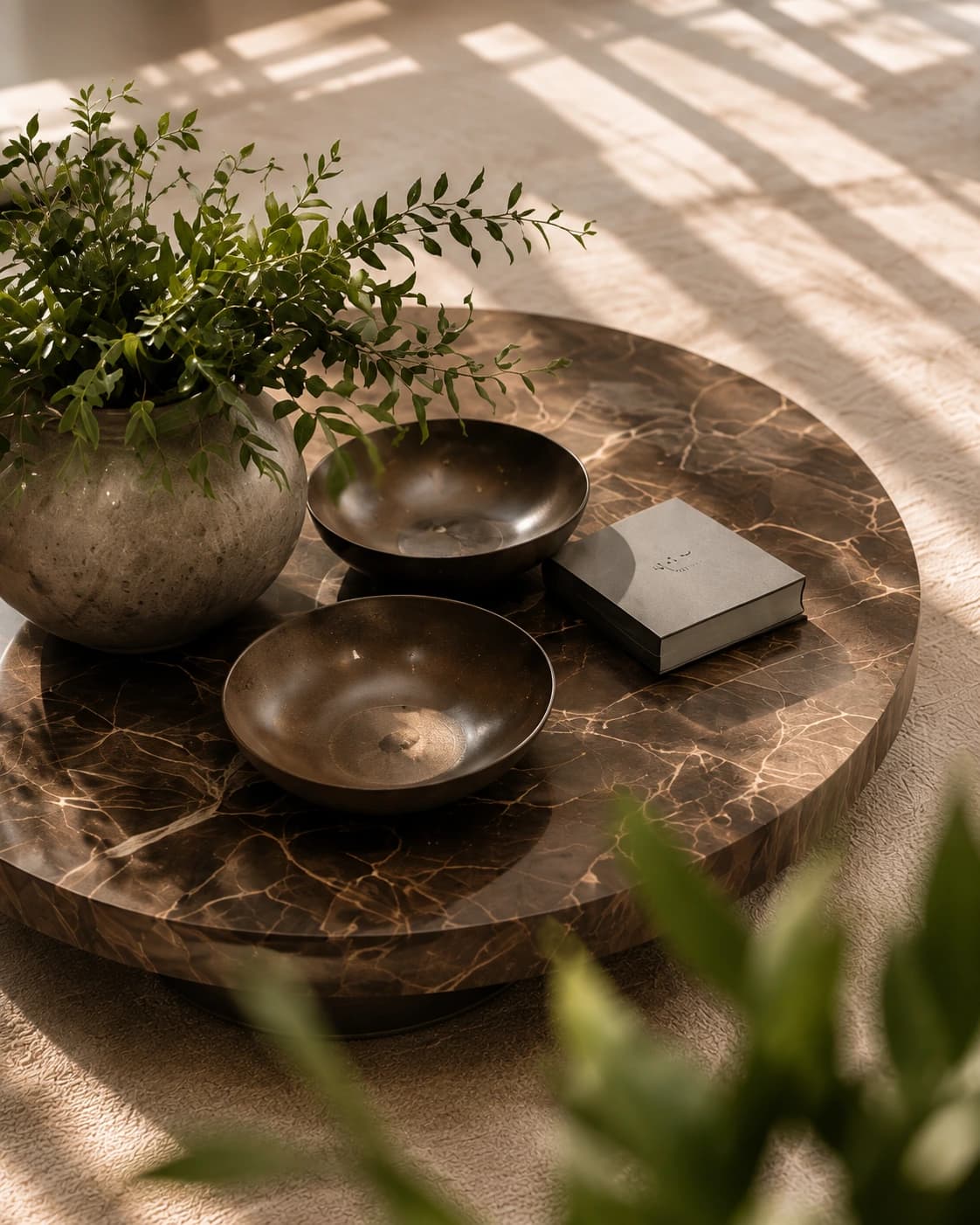 Marble coffee table styled with greenery and ceramics